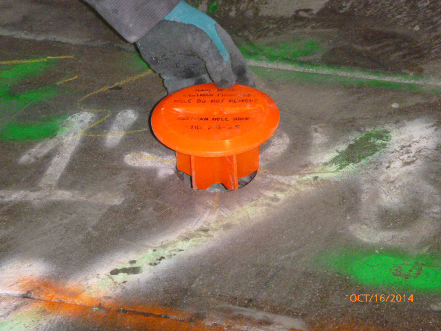 Installing Hartman Dome HHD-2.5-3.5 into a hole in cement floor at a construction site, image 7